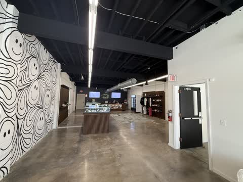 View from the entrance down the White Label Exotics showroom toward the service counter.